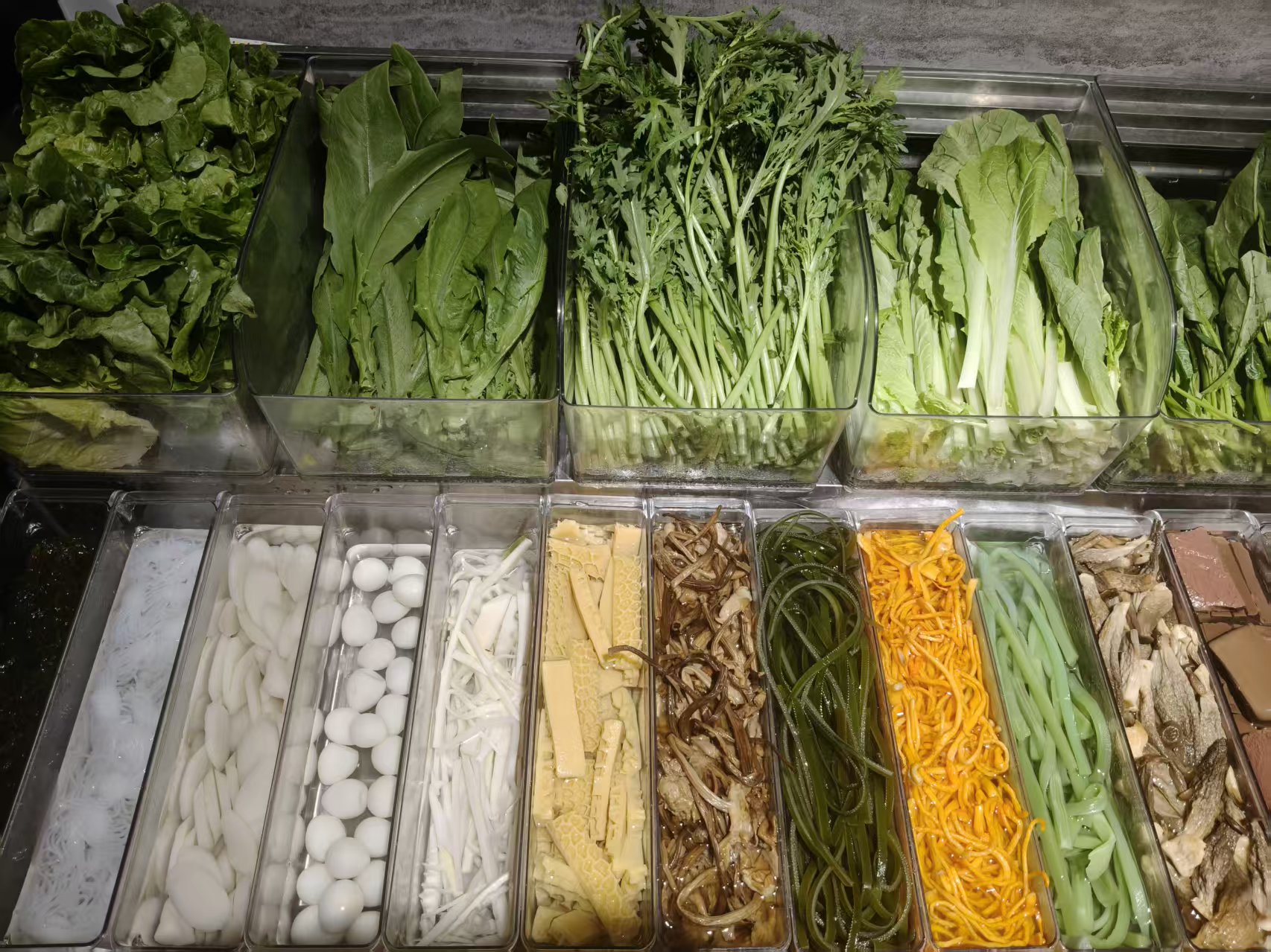 Leafy greens and toppings in trays