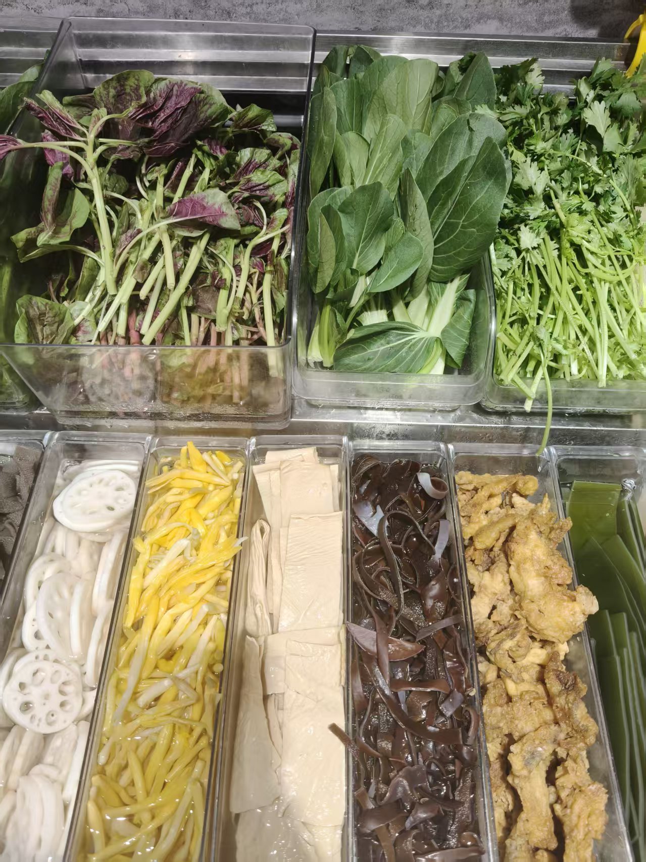 Noodles, vegetables, and mushrooms in trays